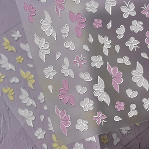 3D embossed nail stickers featuring elegant white butterfly and delicate floral patterns
