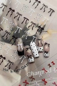 Close-up of AF7608 nail stickers with black and white polka dots and red bow designs