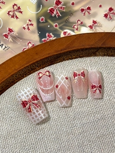 Detail of YT7683 5D embossed nail stickers with red bows, hearts and grid patterns