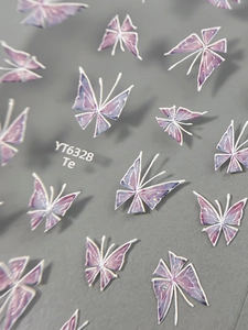 Macro shot of 3D purple butterfly nail stickers showing intricate detail and texture