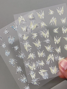 Macro view of iridescent butterfly nail art stickers with laser glitter finish on PET film