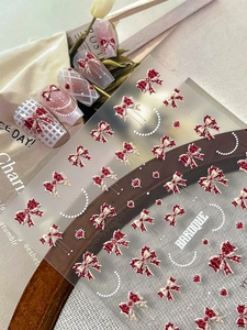 Detailed 3D relief nail stickers featuring red bows, hearts and baroque style patterns