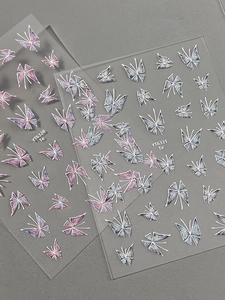 Detail of purple and blue gradient butterfly nail art stickers with glitter finish