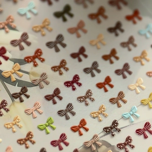 3D embossed bow nail art stickers featuring polka dots and stripes in various colors
