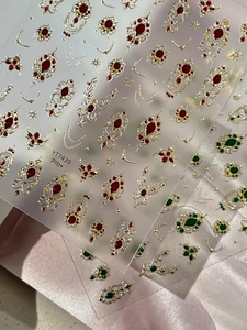 Macro view of vintage Baroque nail art stickers with gold foil and imitation gemstone accents