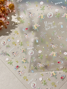 Detailed macro view of 5D embossed nail stickers featuring spring flowers and ponies