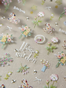 Macro detail of 3D embossed nail stickers featuring floral motifs and horse designs