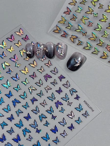Detailed view of holographic butterfly nail art stickers in vibrant gradient colors