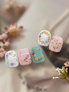 Detail of 3D embossed floral nail stickers with intricate wreath and flower patterns