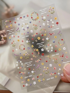 Detail of floral 3D relief nail stickers with colorful flowers and artistic phrases