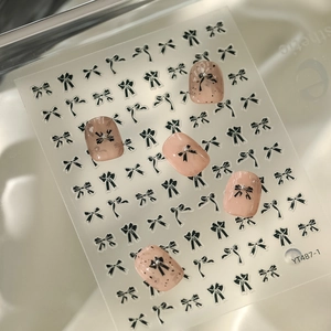 Detail of YT487 black bow nail stickers with 3D beads on pink manicure tips