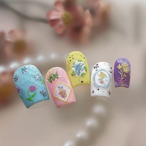 Floral 3D embossed press-on nails with colorful flowers, lace, and bird designs