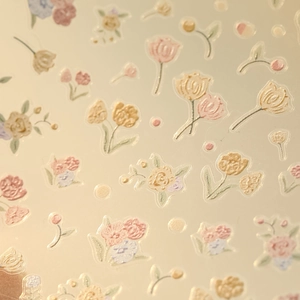 Close-up of tulip flower nail stickers with embossed texture and hand-painted floral details