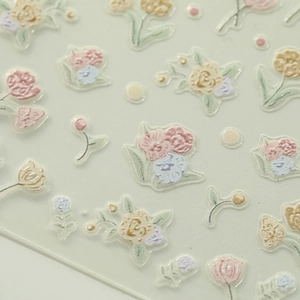Detailed macro view of 3D embossed floral nail stickers with gold edges and tulip patterns