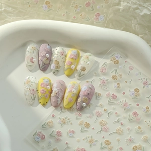 Macro detail of tulip 3D embossed nail art stickers with purple floral press-on nails
