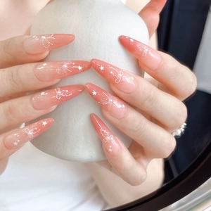 Macro detail of 5D embossed nail stickers featuring pink gradient and white bow design