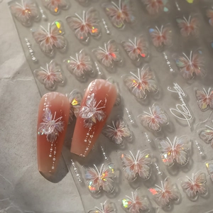 Detail of pink butterfly nail art stickers with iridescent glitter and lace texture