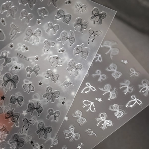Detail of 5D embossed bow and star nail stickers in black and white styles, model YT3703