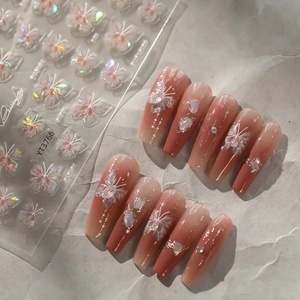 Detail of pink gradient fake nails with 3D laser butterfly stickers and shell texture