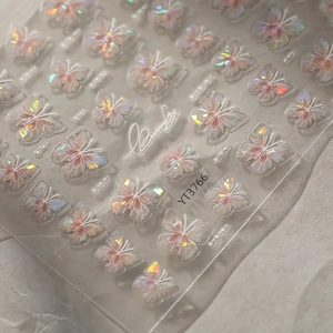 Macro shot of butterfly nail art stickers with aurora laser effect on transparent film