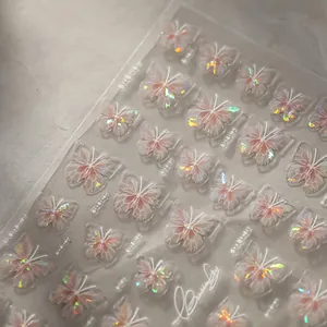 Detailed macro of 3D holographic butterfly nail art stickers with light pink pearlescent finish