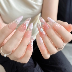 Pink jelly stiletto nail stickers with embossed floral patterns and gold glitter accents