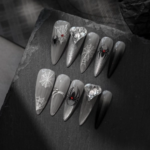 Gothic stiletto press-on nails with black spider webs, red rhinestones and silver glitter