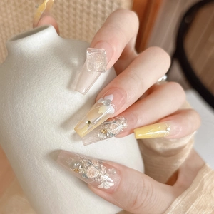 Detail of long coffin press-on nails with 3D floral relief and gemstone decorations
