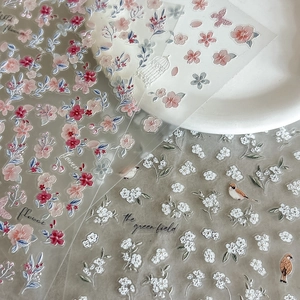 Embossed floral and bird nail art stickers featuring peach blossom and butterfly designs