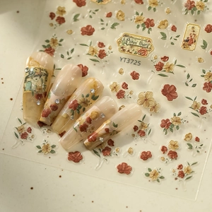 Macro detail of retro rose nail stickers with 3D embossed floral patterns and rhinestones