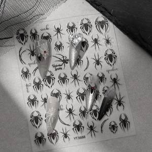Detail of spider web nail art stickers with 3D black spider patterns and gothic text