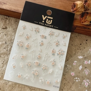 Detail of vintage embossed rose and butterfly nail stickers in premium packaging