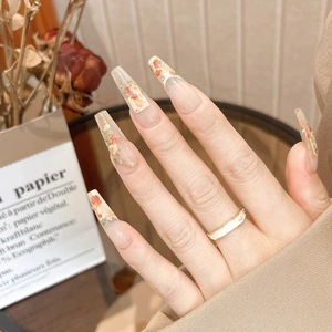 Macro detail of press-on nails with 3D floral oil painting art and rhinestones