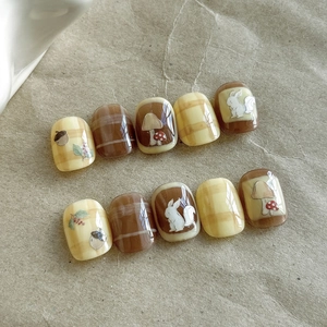 Detail of forest animal nail stickers showing squirrel and mushroom relief art