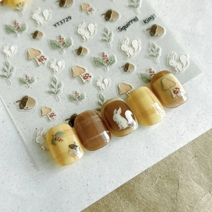 Detailed relief nail stickers featuring forest motifs like squirrels and mushrooms