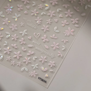 Detail of pink cherry blossom nail stickers with iridescent petals and heart patterns