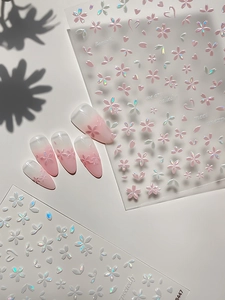 Detailed macro view of 5D embossed pink cherry blossom nail art stickers with holographic finish