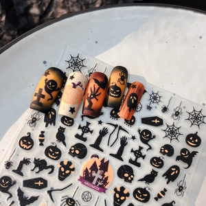 Halloween nail art stickers with pumpkin bat ghost designs on a clear adhesive sheet