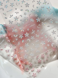 Macro shot of 3D laser cherry blossom nail stickers with holographic shell luster finish