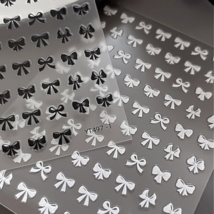 3D embossed nail stickers featuring black and white bow designs for DIY nail art decoration