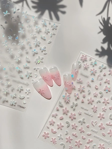 Detail of 3D embossed cherry blossom nail stickers with iridescent white and pink petals