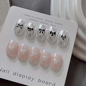 3D relief nail art stickers featuring black and white bows with metallic finish