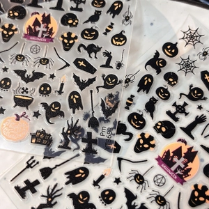 Detail of Halloween nail stickers featuring pumpkins, bats and ghosts on transparent film