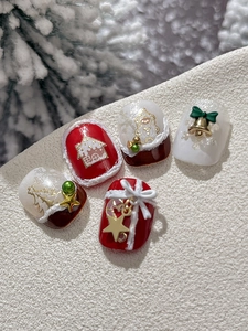 Macro view of Christmas nail stickers featuring gingerbread house and golden tree