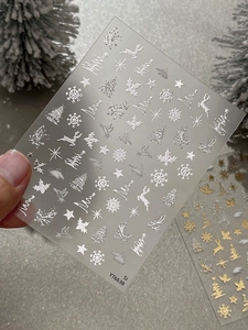 Detail of silver Christmas nail stickers with 3D embossed snowflake and elk patterns