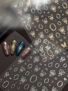 Macro shot of gold and silver butterfly embossed nail stickers with holographic shimmer