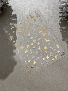 Detail of silver Christmas nail stickers with reindeer and snowflake patterns