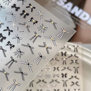 Gold stamping bow nail art stickers featuring black and white elegant ribbon designs