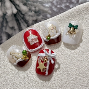 Christmas nail art set with gingerbread man, tree, and golden star embossed decorations