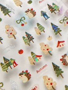Vista macro di adesivi autunnali con ricci, alberi e dettagli glitterati laser 3D